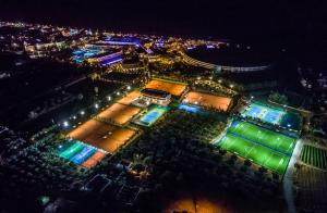 an overhead view of a tennis court at night at Lyttos Beach in Hersonissos