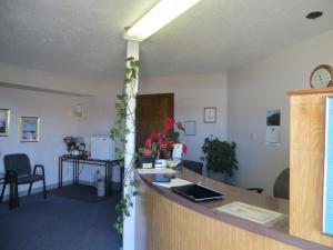 an office with a counter and a desk with a laptop at Budget Inn Adair in Adair
