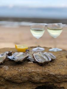 two wine glasses sitting on top of a rock at Camping La Prée in Les Portes