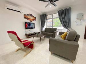 a living room with a couch and chairs and a tv at Langkawi Cozy Holiday Home at Bukit Indah by Zervin in Kuah