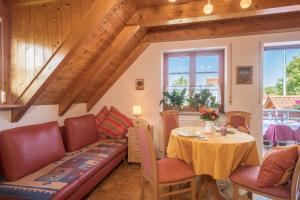 a living room with a table and a couch at Haus Desor in Kressbronn am Bodensee