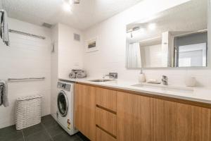 a bathroom with a sink and a washing machine at Wintersview 8 - Lennox Head in Lennox Head