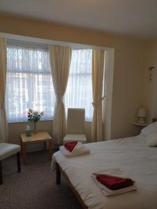 a bedroom with a white bed and a window at Sheridan in Scarborough