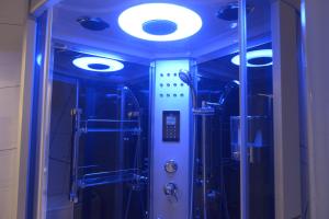 a shower with blue lights in a room at Stefanos Resort in Mesongi