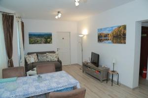 a living room with a table and a couch at Casa Tinkerbell in Sovata