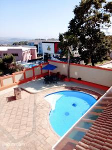 a swimming pool on the roof of a building at Singatha Guesthouse in Durban