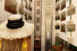 a large straw hat on display in a building at St Raphael Resort in Limassol