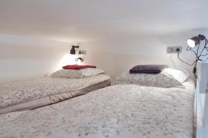 two beds in a room with white walls at Bigland House in Saint Petersburg