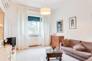 a living room with a couch and a tv at Marradi Apartment with Balcony in Livorno
