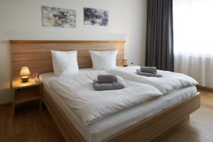 a large white bed with two pillows on it at Hotel Weimarer Berg in Apolda