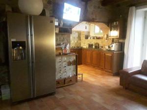 eine Küche mit einem Kühlschrank aus Edelstahl in einem Zimmer in der Unterkunft All'Ovile in Montevescovo