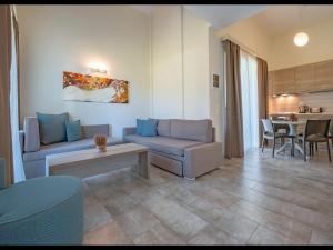 a living room with a couch and a table at Villas Marajo in Skala Potamias