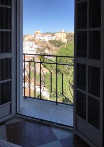 an open door to a balcony with a view at Casa Marta in Setenil