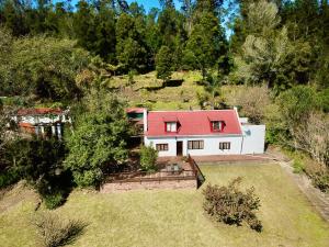 an aerial view of a white house with a red roof at Masescha Country Estate in Plettenberg Bay