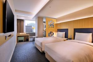 Un pat sau paturi într-o cameră la Hotel Midcity Myeongdong