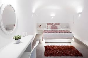 a white bedroom with a bed and a mirror at Finikia -Foinikia - Luxury Cave - A Wonderful 2 Bedroom Villa - Hot Tub in Foinikiá