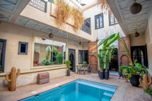 a house with a swimming pool in a courtyard at Riad Spa Sindibad in Marrakech