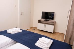 A bed or beds in a room at Kincses Sziget Apartman