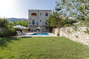 an external view of a house with a swimming pool at Villa Ahlades in Achlades