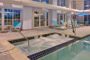 a hot tub in the middle of a swimming pool at Holiday Inn Express Hotel & Suites Petoskey, an IHG Hotel in Petoskey