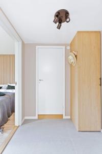 a bedroom with a door and a bed and a ceiling at BJØRVIKA APARTMENTS, Teaterplassen, Oslo city center in Oslo