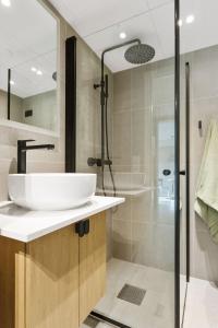 a bathroom with a sink and a shower at BJØRVIKA APARTMENTS, Teaterplassen, Oslo city center in Oslo