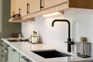 a kitchen with a sink and a counter top at BJØRVIKA APARTMENTS, Teaterplassen, Oslo city center in Oslo