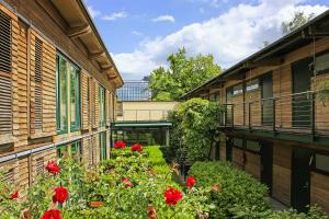 a balcony with red flowers on the side of a building at Scheck Hotel in Munich