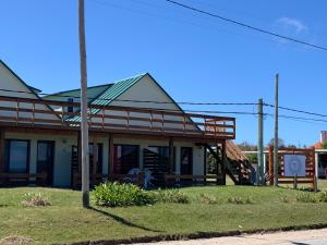 um edifício antigo com um alpendre numa rua em Sabai Casas de Playa em La Paloma