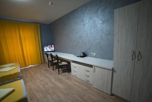 a room with a desk and chairs in a room at Rivne Hostel in Rivne