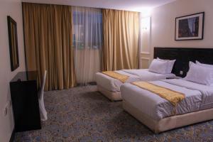 Postel nebo postele na pokoji v ubytování Rollins Hotel + 29 fotografií