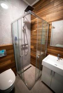 a bathroom with a shower and a toilet and a sink at Rivne Hostel in Rivne