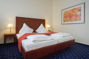 Ein Bett oder Betten in einem Zimmer der Unterkunft Strandhotel Ostfriesenhof