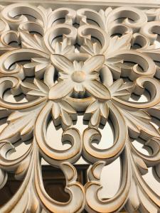 a wooden carving of flowers on a wall at Modern Classic on Kiraly in Budapest