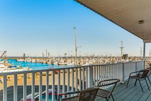 a balcony with chairs and a marina with boats at Westport Marina View in Westport