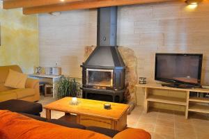 a living room with a fireplace and a tv at Finca Sa Rota de Son Ramon 132 by Mallorca Charme in Llubí