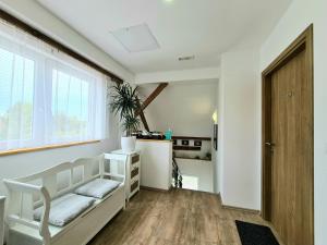 a bedroom with a white bed and a window at Rooms Garden in Slunj