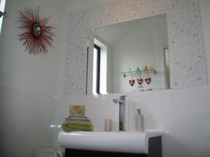 a bathroom with a sink and a mirror at West Melton Bed and Breakfast in West Melton