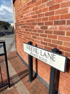 a street sign in front of a brick building at Stunning Marina apartment Gosport Portsmouth in Gosport