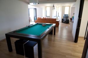 a living room with a pool table and a couch at Villa Mediterraneo in Fuscaldo