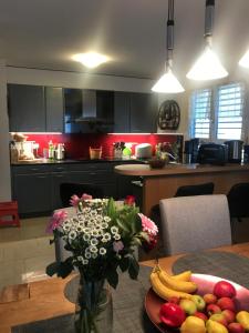 a kitchen with a table with fruits and vegetables on it at Chambre d hôtes Le Petit Bonheur in Colombier