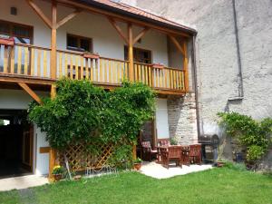 a house with a balcony and tables and chairs at Pension Rondel in Poděbrady