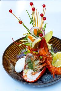 a plate of food with seafood and vegetables on it at Hotel The Century in Hasselt