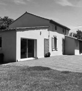 une photo en noir et blanc d'une maison dans l'établissement Gîte au Haras, à Les Aubiers