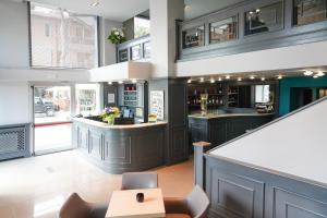 a kitchen with dark cabinets and a bar at Sole Mare in Ventimiglia