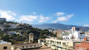 a view of a city with buildings and mountains at DWO Nopal in Puerto de la Cruz