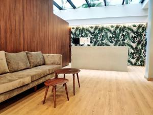 a living room with a couch and two stools at DWO Nopal in Puerto de la Cruz