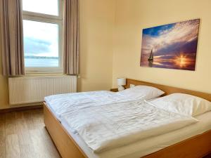a bedroom with a bed with a large window at Hotel Kieler Förde & Free Parking in Kiel +32 photos