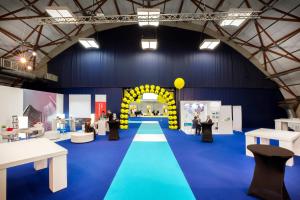 a large room with a blue floor and a yellow arch at Crowne Plaza Milan Linate, an IHG Hotel in San Donato Milanese