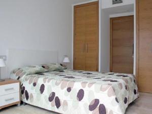 a bedroom with a bed and two wooden doors at Zahara Centro in Zahara de los Atunes +24 photos